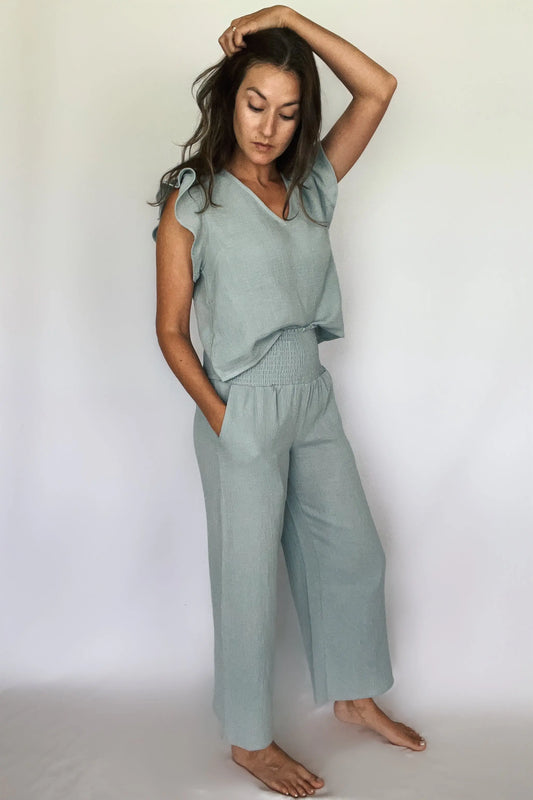 A model showcasing sea blue cotton gauze smocking waist pants paired with matching top