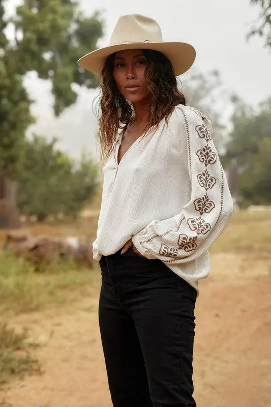 A female model showcasing a Embroidered Long Sleeve Boho Blouse