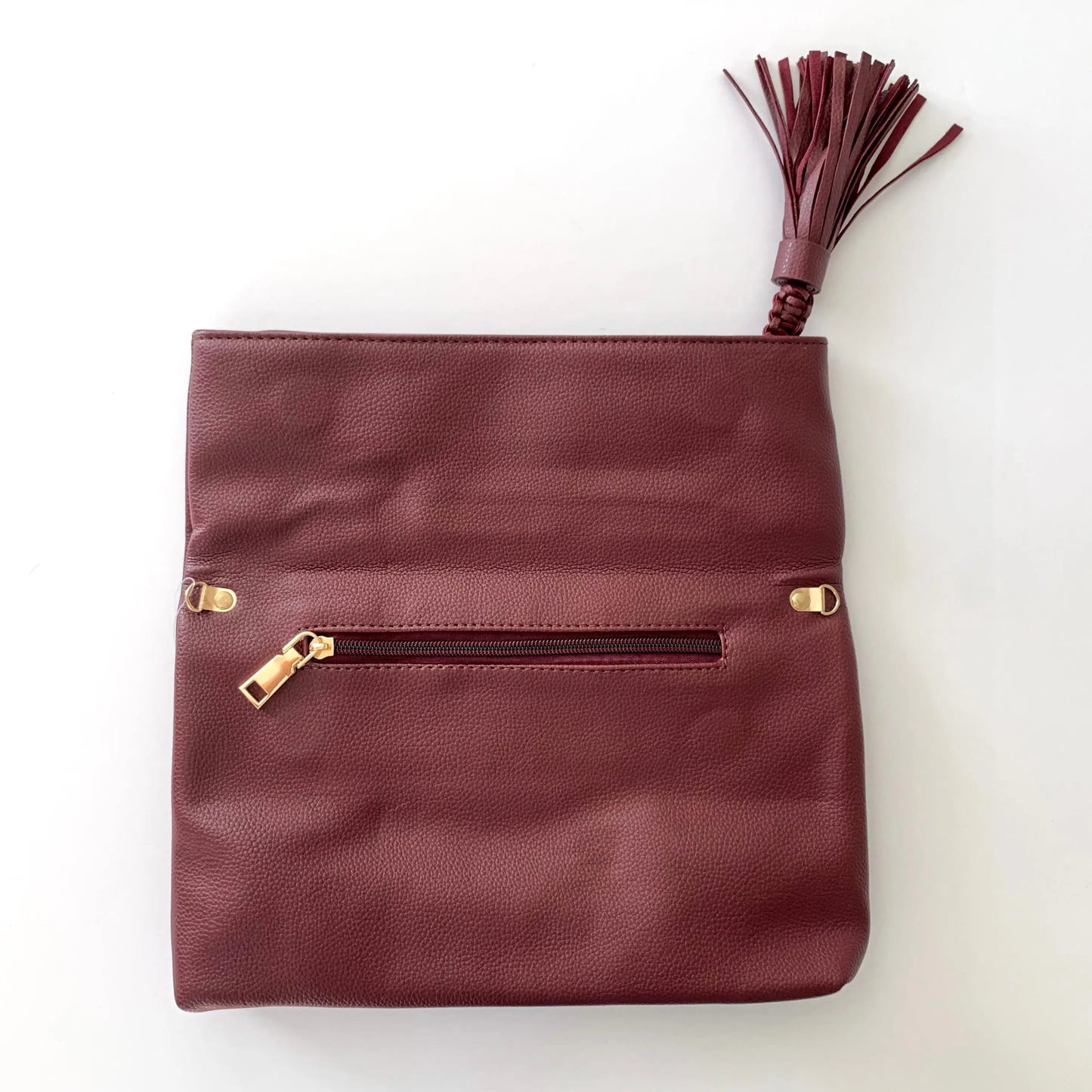 The Tiny Details Burgundy Smooth Folded Tassel Clutch