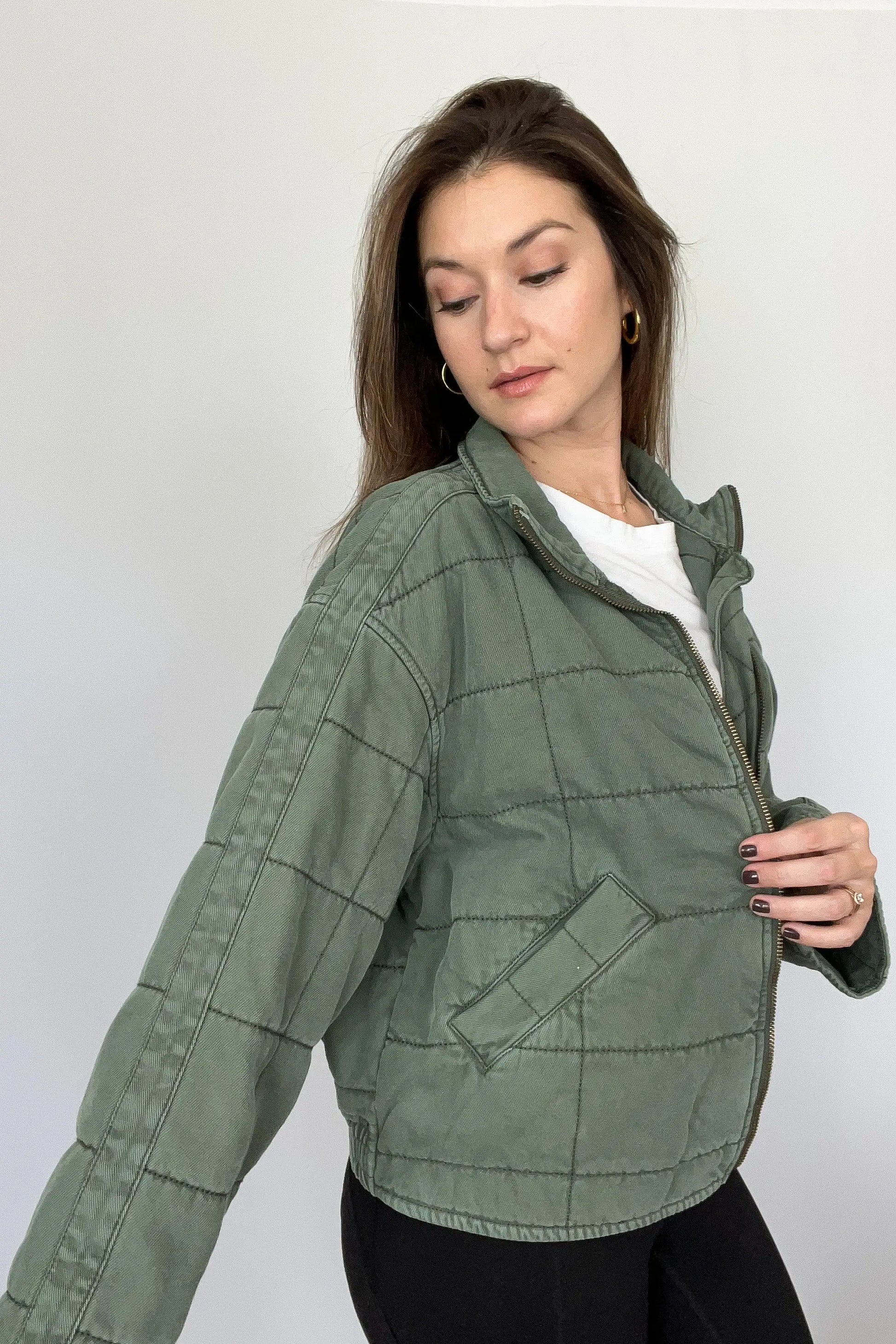 The Tiny Details modeling a Green Dolman Quilted Denim Jacket for women