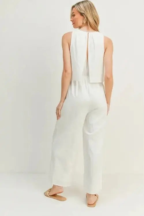 A woman modeling a white wide-leg sleeveless jumpsuit