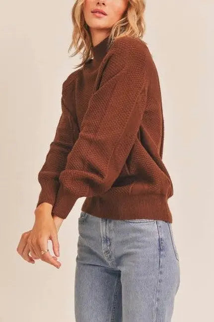 A female modeling the Walnut Mock Neck Pattern Woven Sweater