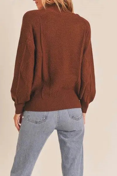A female modeling the Walnut Mock Neck Pattern Woven Sweater